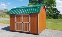 Highwall barn wood siding with mahogany stain, buckskin trim, and forest green metal roof