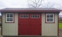 Saltbox shed with clay wood siding and jamestown red trim